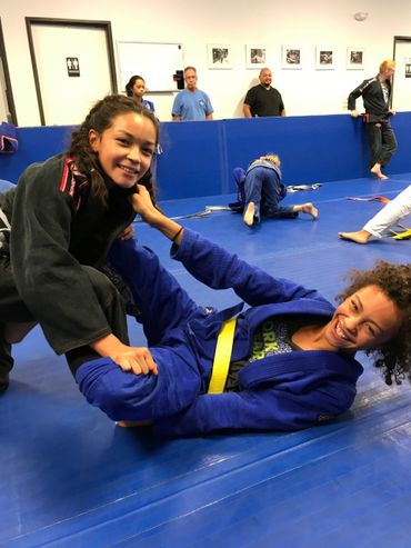 Young students training jiu jitsu on the mats at Dunham Jiu Jitsu